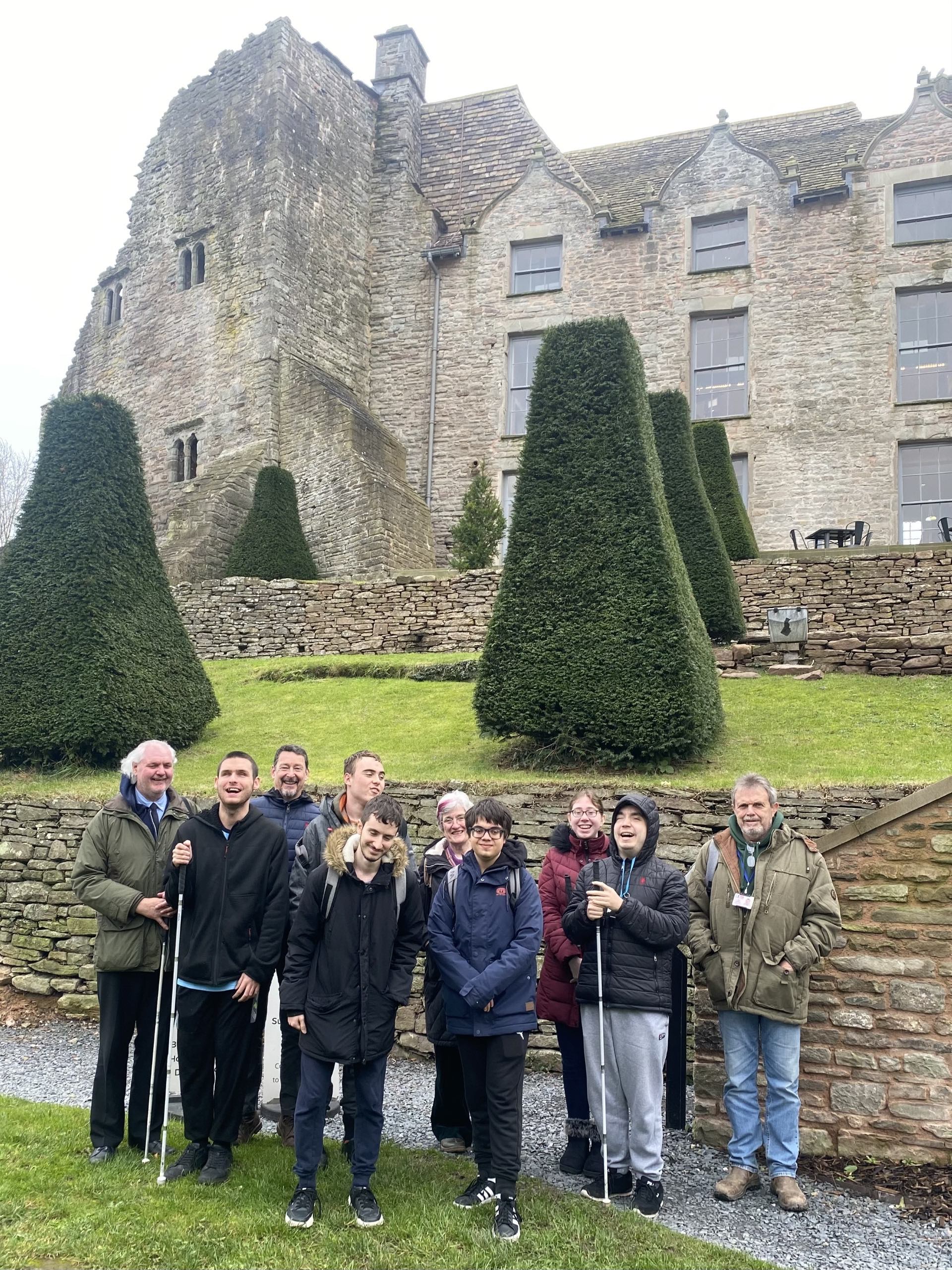 the group of staff, students and volunteers standing in front of Hay Castle