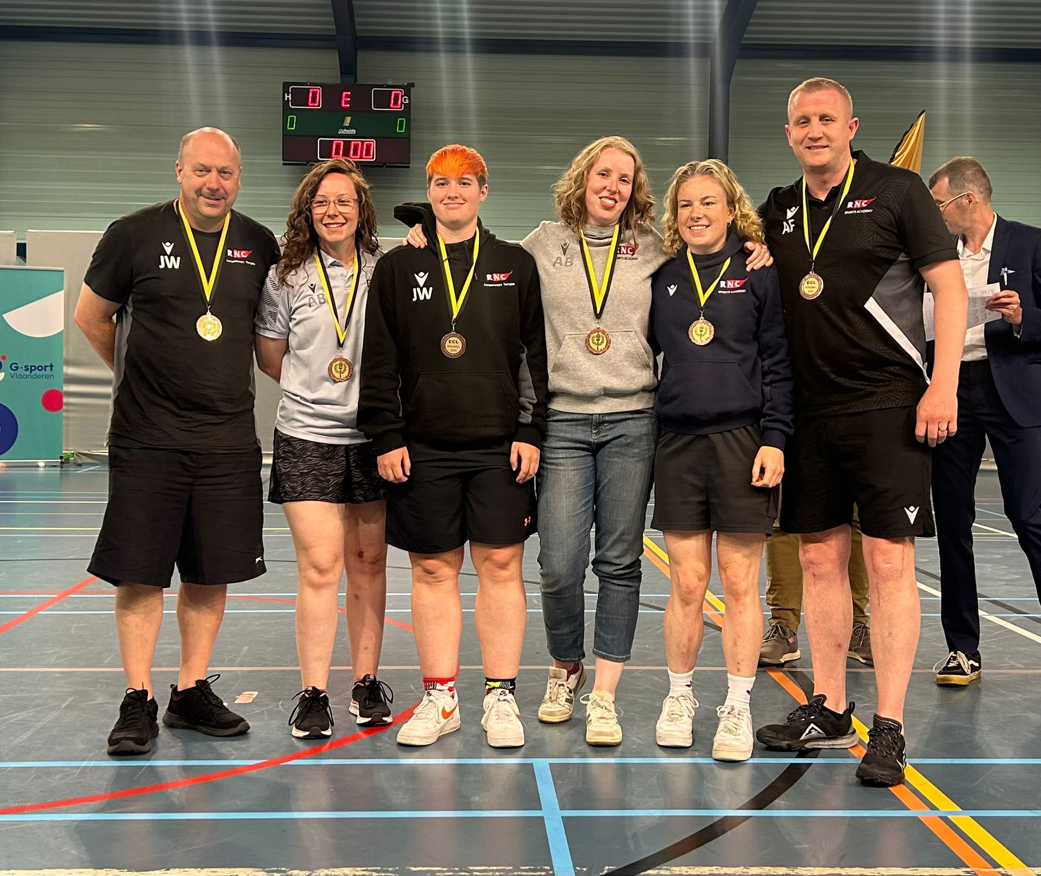 The RNC team wear their medals along with coaching staff Jim and Aaron