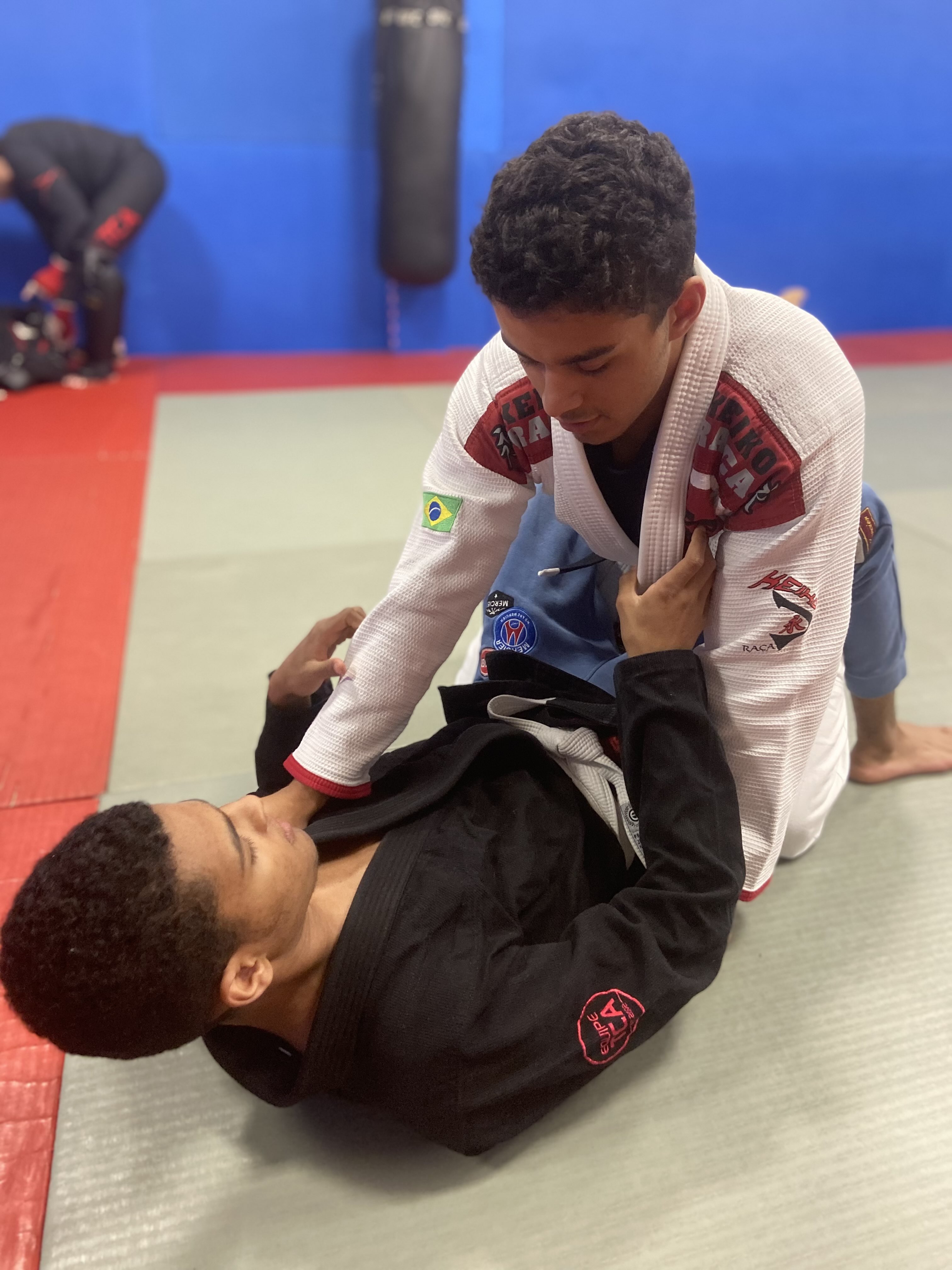 two students in hold on the jiu-jitsu mat