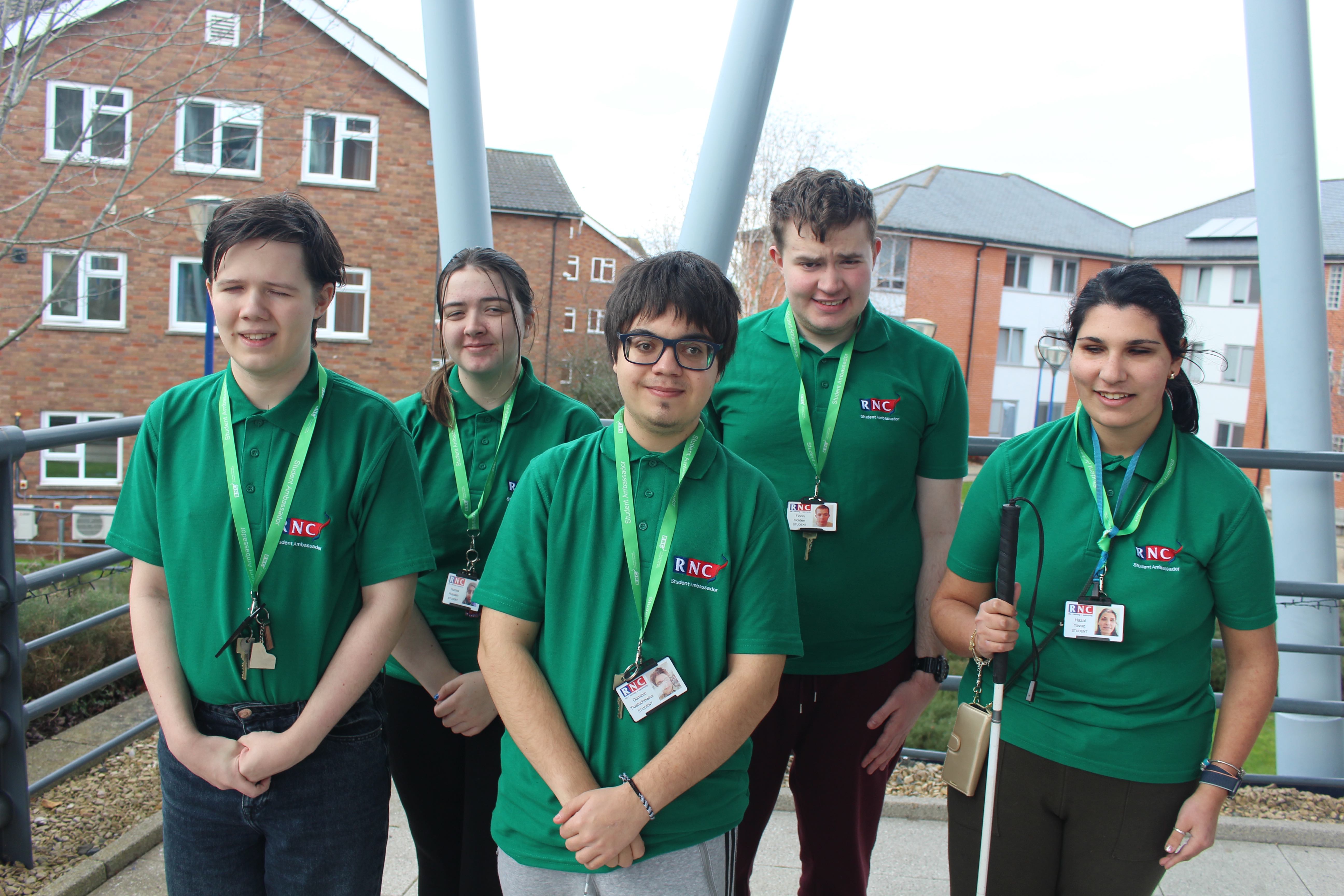 The group of five student ambassadors dressed in their green ambassador polo shirts and lanyards