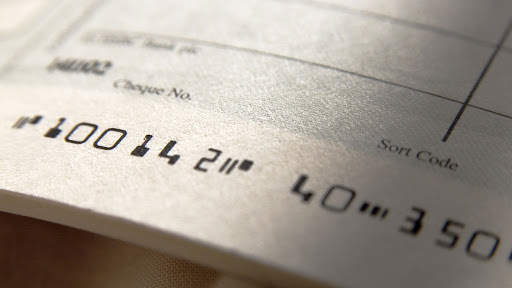 a close up of an unwritten cheque in a cheque book