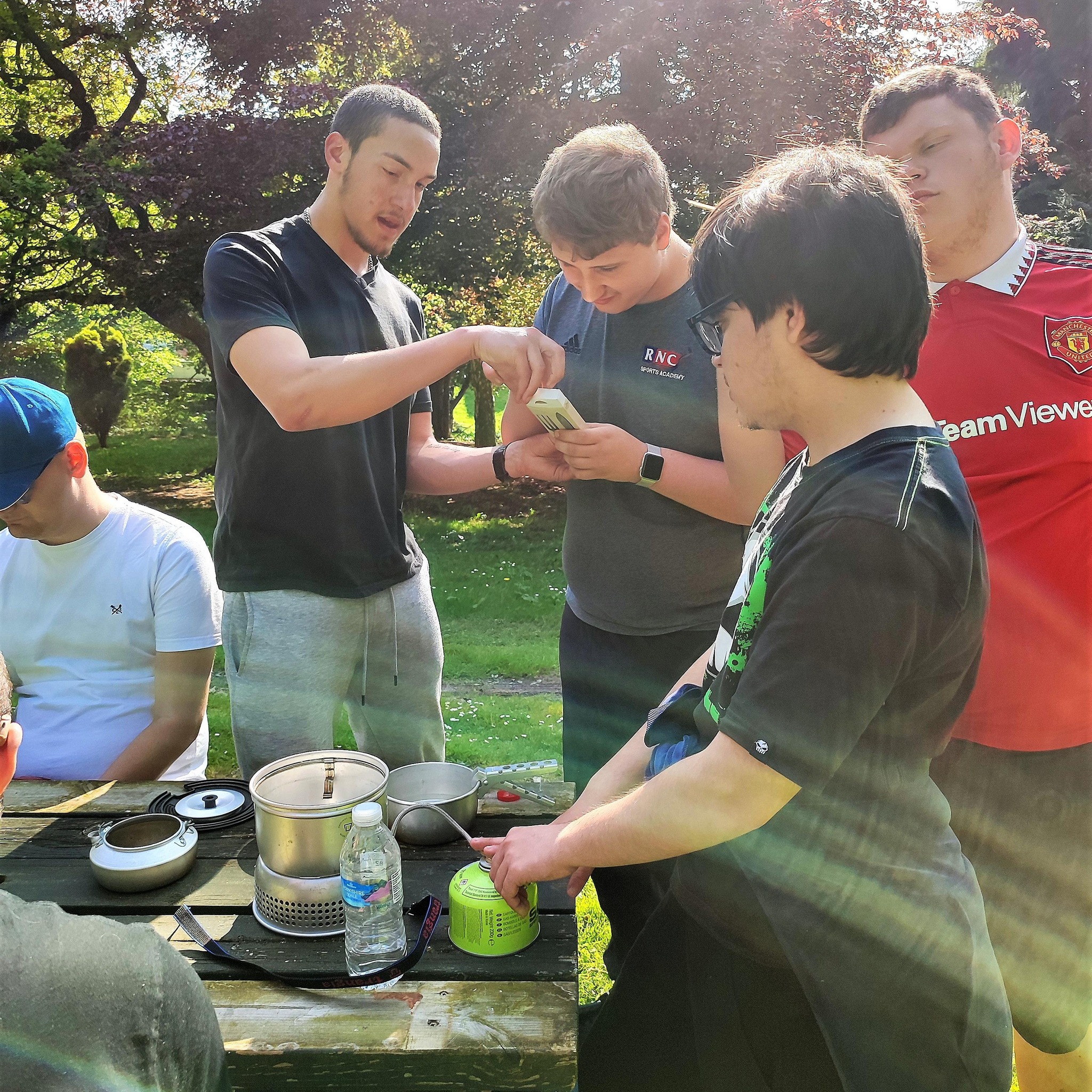 a group of students lighting the Trangia stove