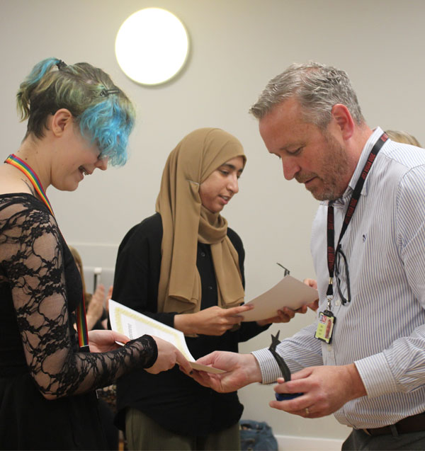 Two students receiving their awards from two members of staff