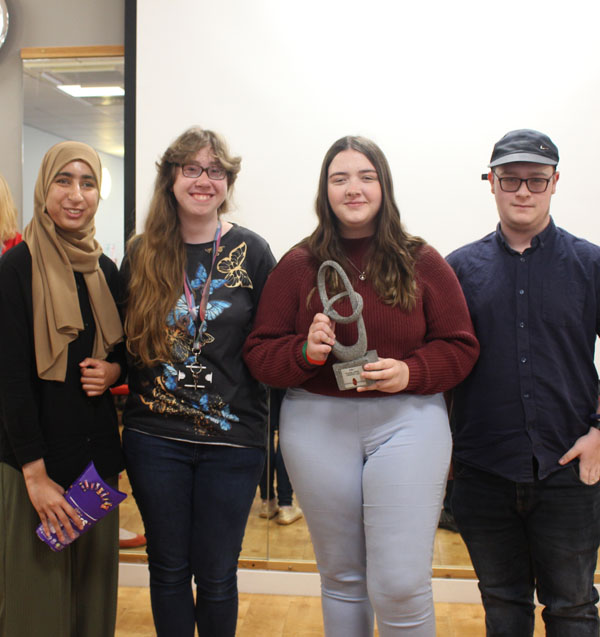 Four students of the winning team with their award