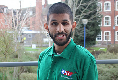 Picture of Shamreaz smiling and wearing a green RNC polo shirt.