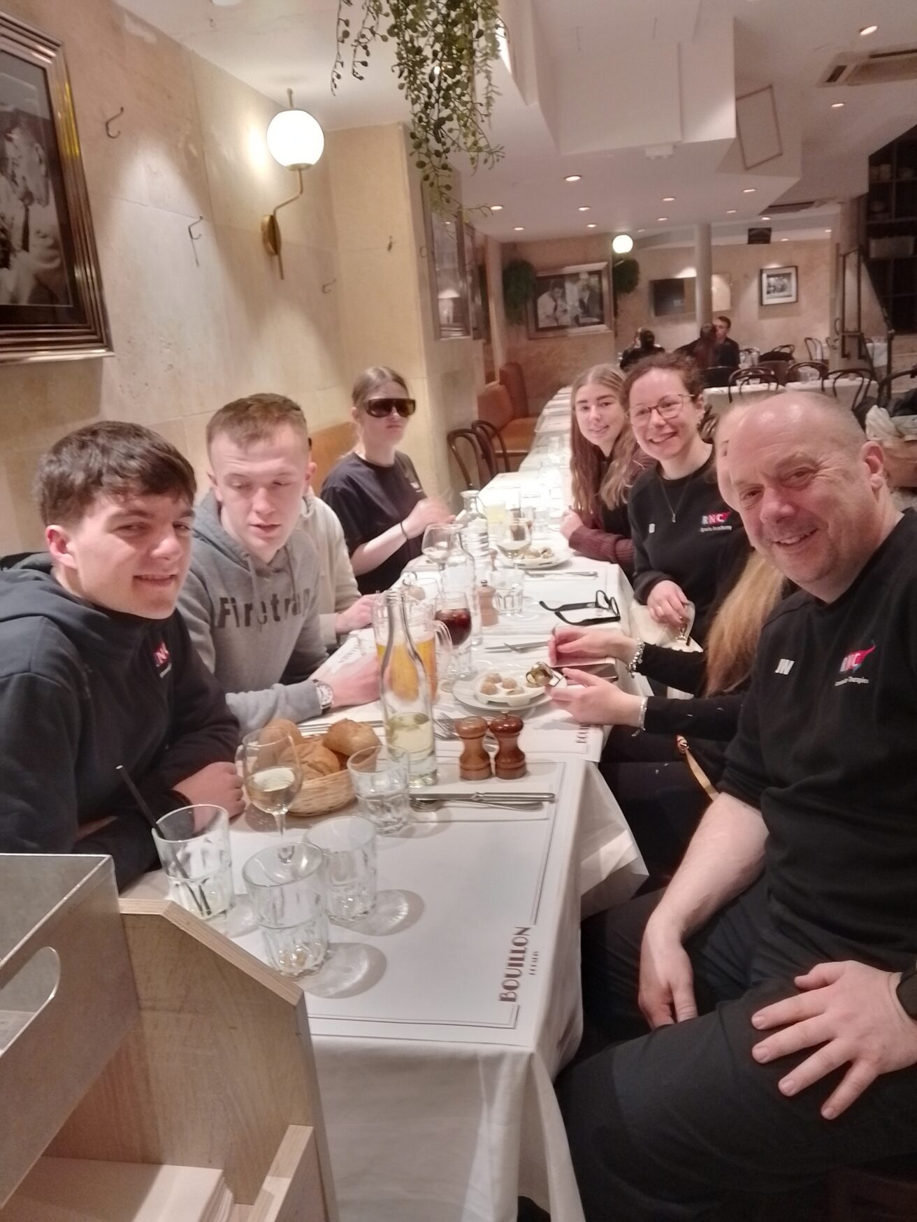 The RNC staff and student group sitting in the restaurant waiting to try out some French cuisine