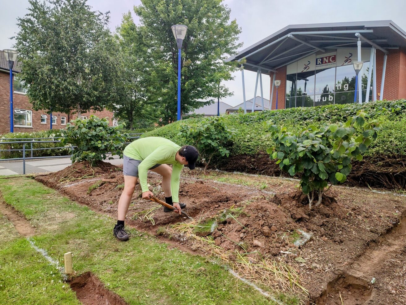 Aaron is digging out the trenches ready to slot in the railway sleepers to create raised beds