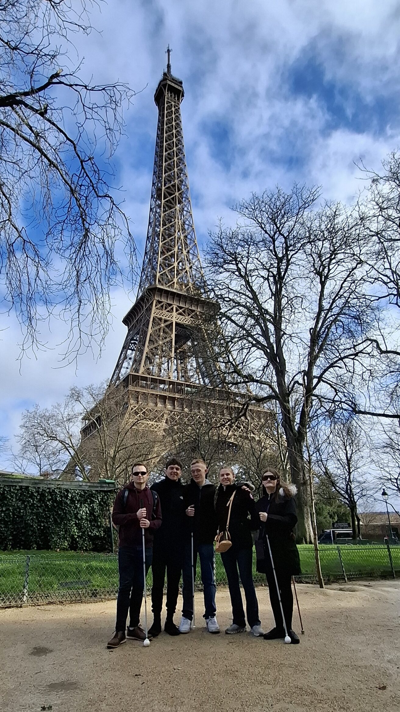 The group stand in front of the iconic Eiffel Tower