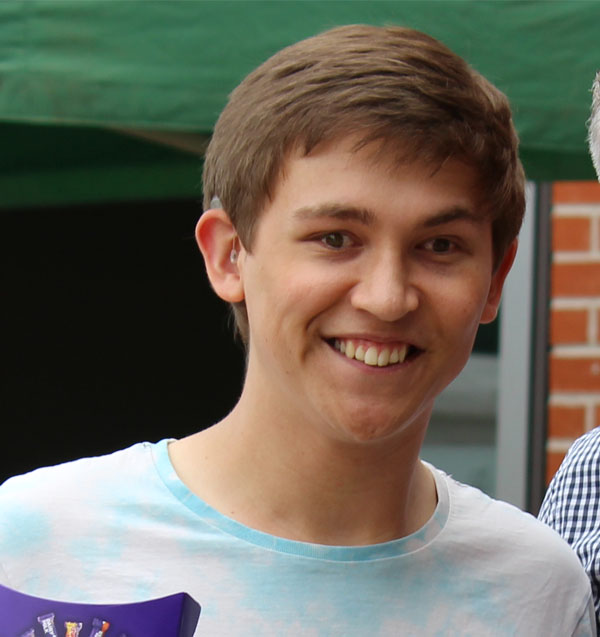 A headshot of Max smiling