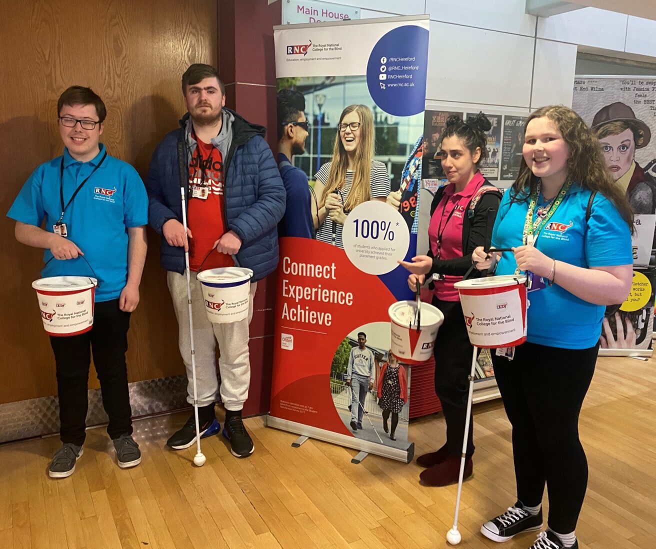 This picture shows students from L-R: Will, Jack, Gabs and Lorna with their collection buckets in the foyer of the theatre.