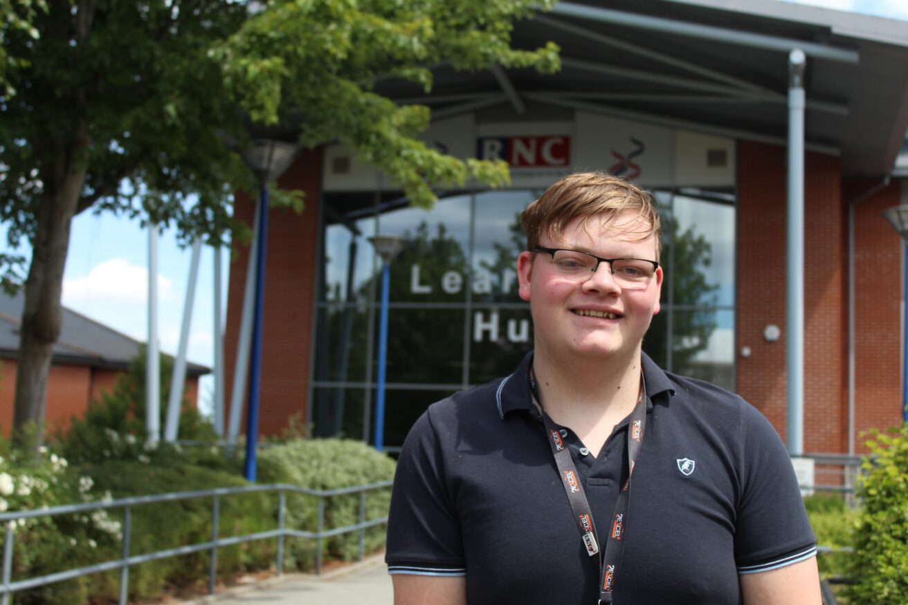 Harvey standing in front of the Learning Hub entrance