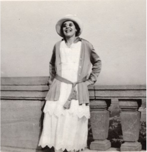 Dorothy is pictured standing at the top of Mount Royal, Montreal. She is wearing a hat and sunglasses and has a beaming smile