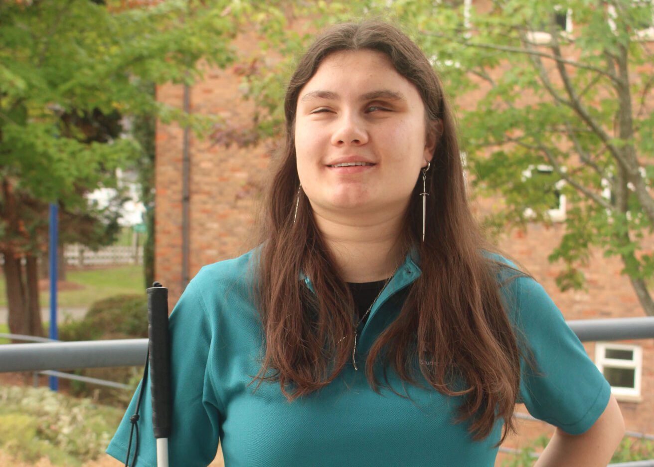 Head and shoulders portrait of Ana wearing her dark green student ambassador polo shirt