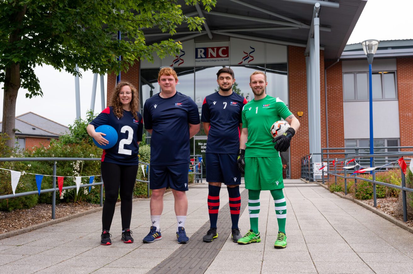 4 people wearing sports academy kit standing in front of the entrance to the College