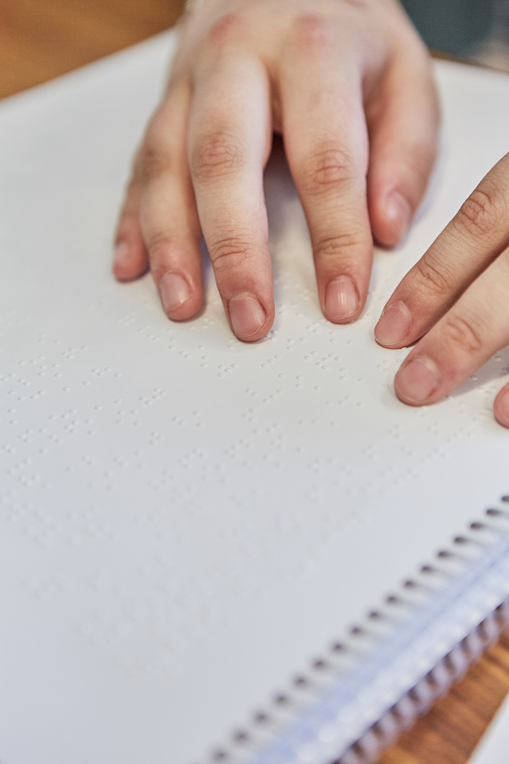 Hands reading Braille